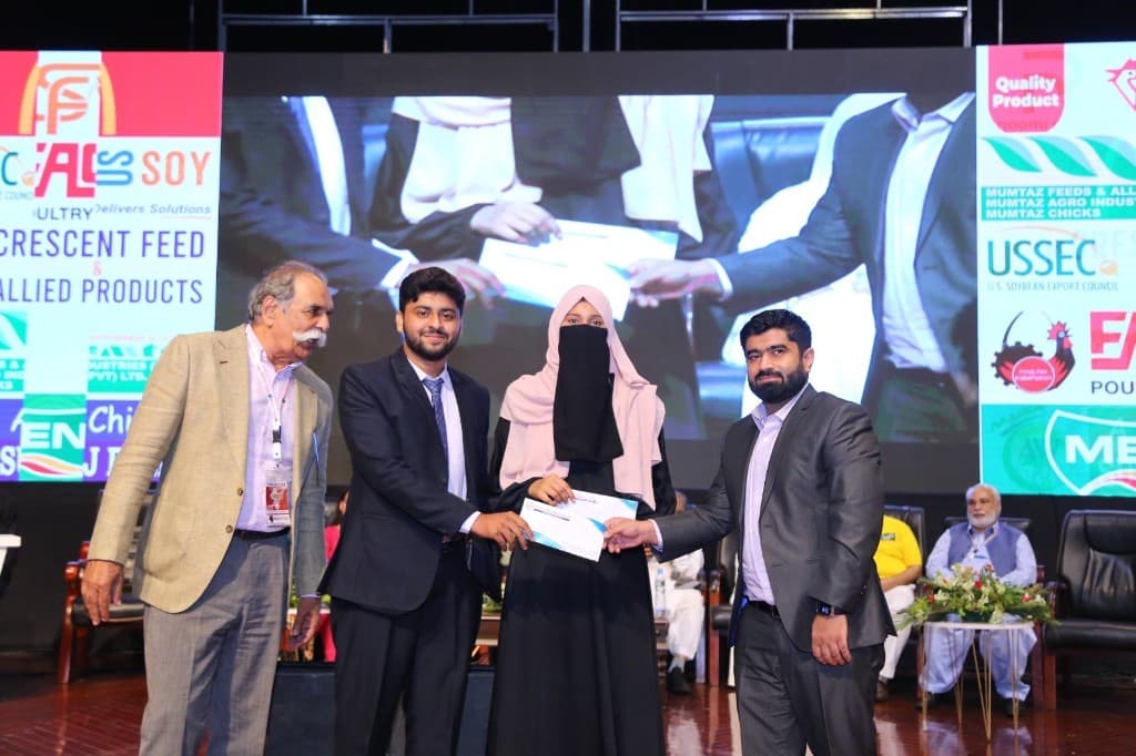 Certificate presentation with International Poultry Expo 2023 stage backdrop